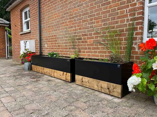 Two dipping tank water butts linked together for more sustainable rainwater harvesting